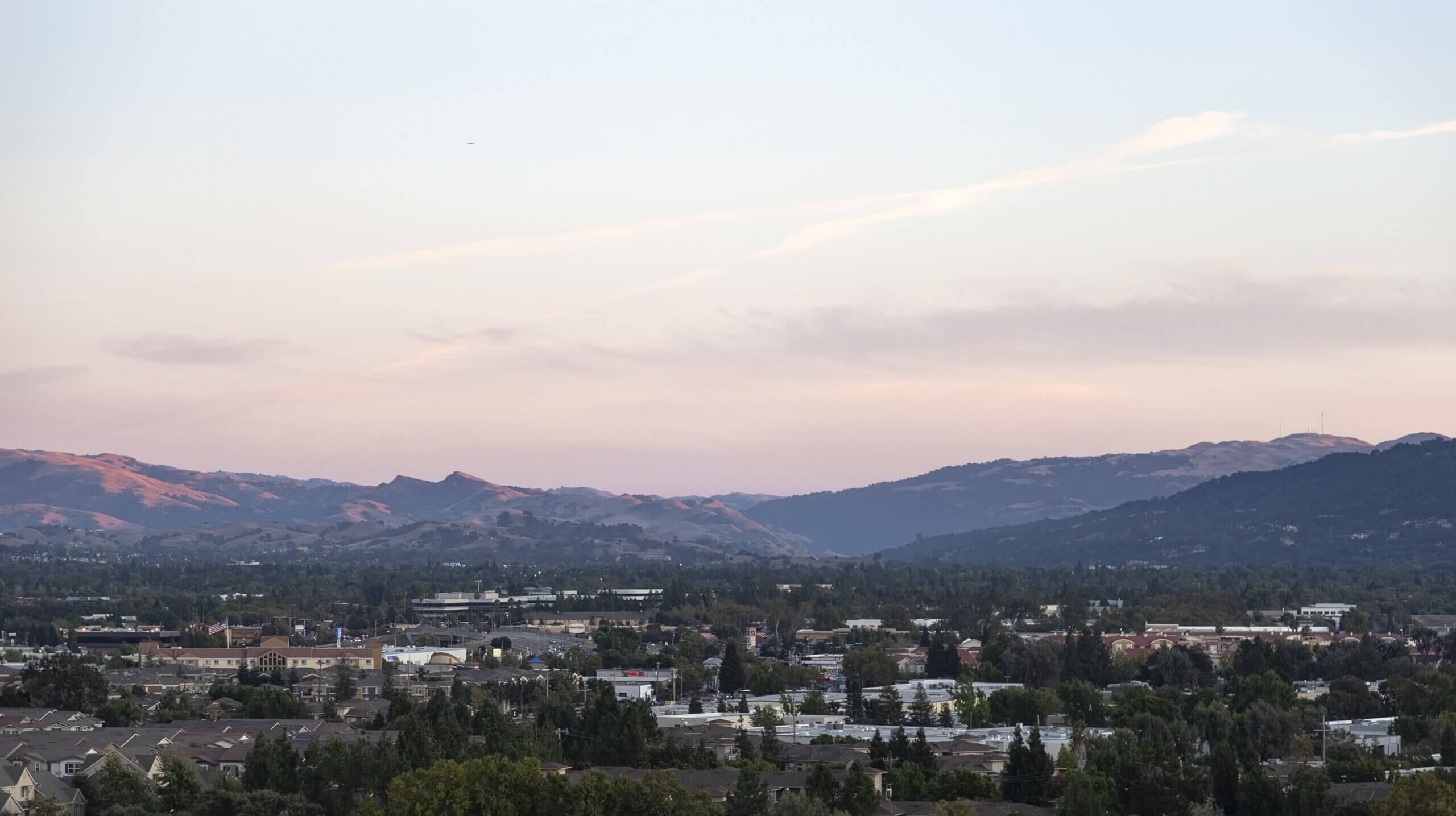 Beautiful shot of the Dublin, CA buildings near mountains under a cloudy sky